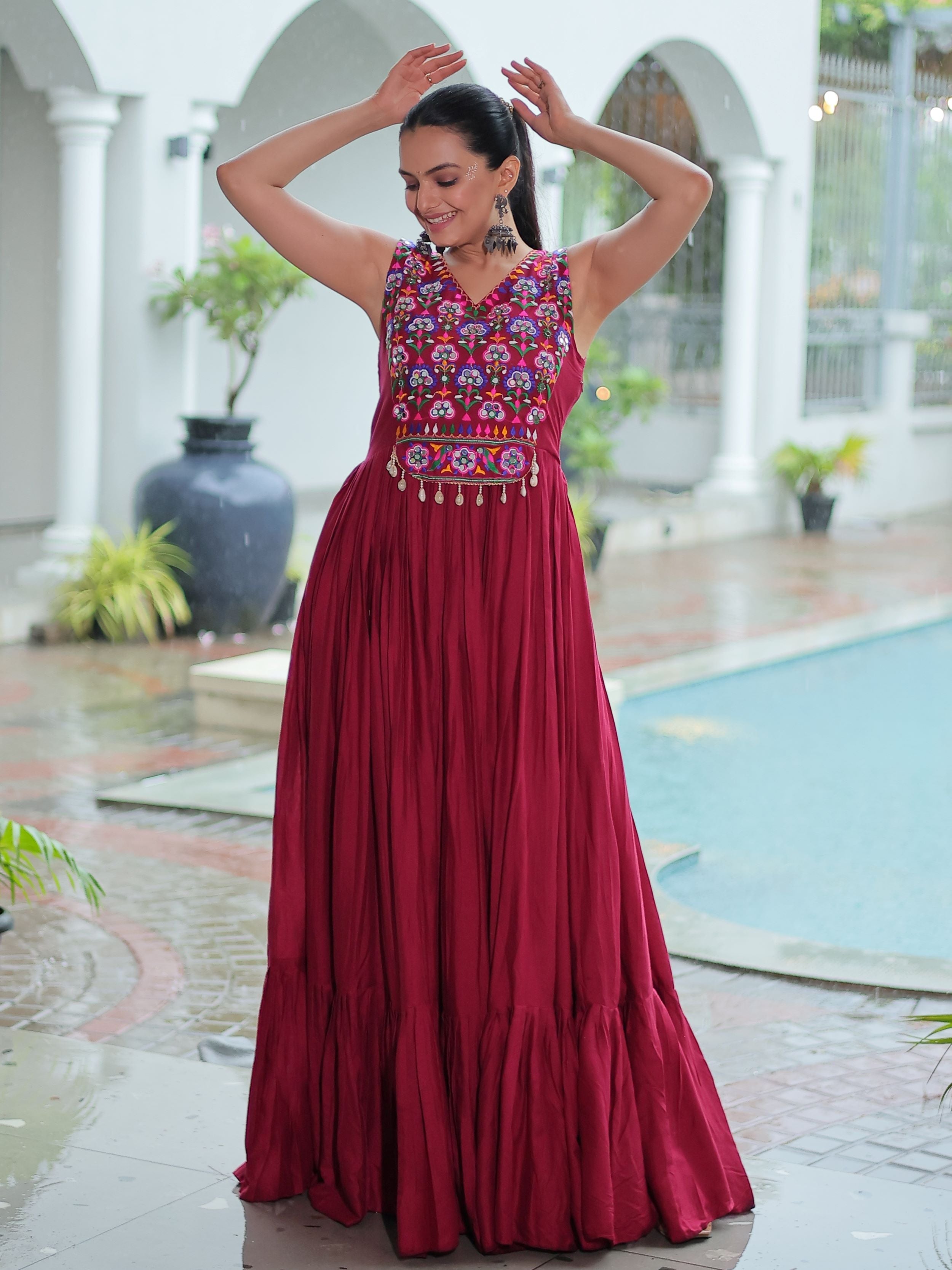 Maroon rayon sleeveless gown with kutchi gamthi embroidery and mirror work