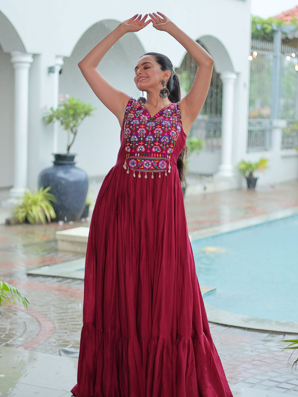 Maroon rayon sleeveless gown with kutchi gamthi embroidery and mirror work