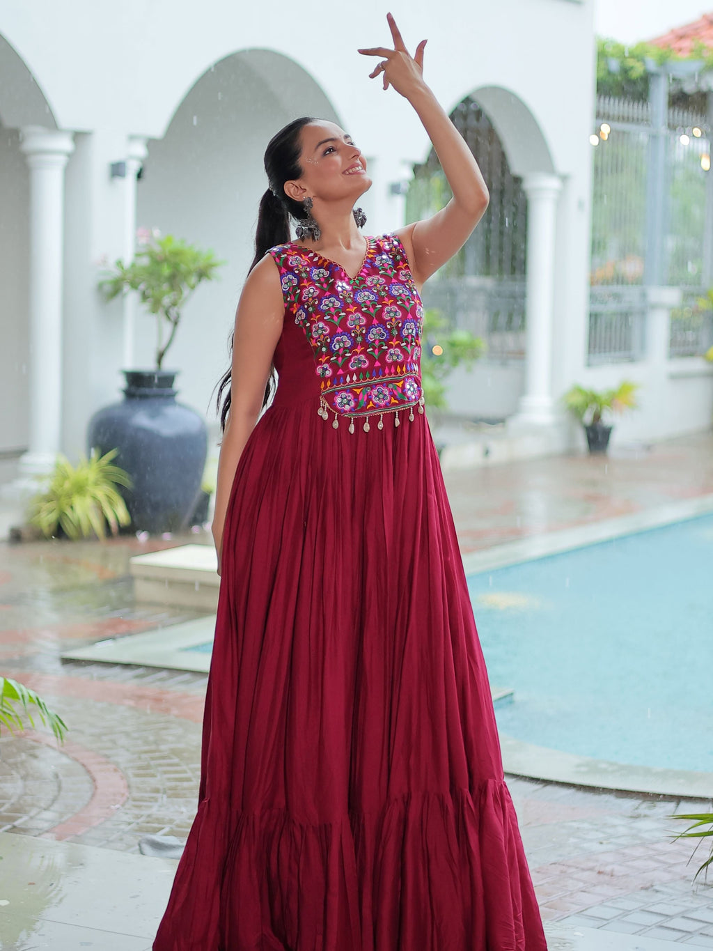 Maroon rayon sleeveless gown with kutchi gamthi embroidery and mirror work