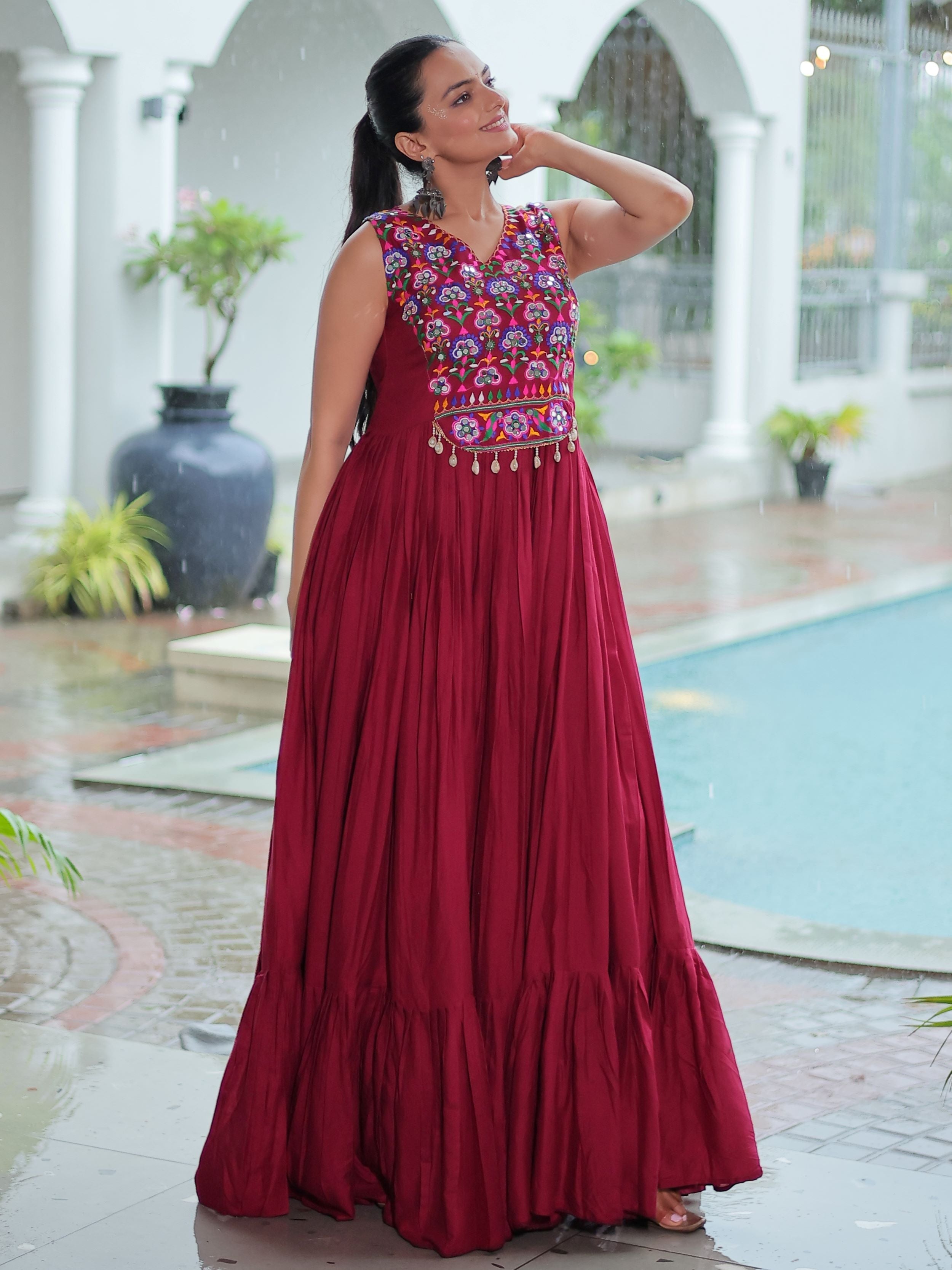 Maroon rayon sleeveless gown with kutchi gamthi embroidery and mirror work