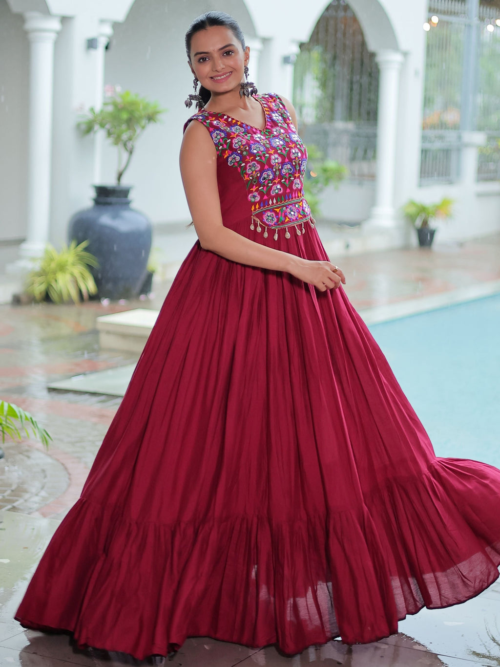 Maroon rayon sleeveless gown with kutchi gamthi embroidery and mirror work