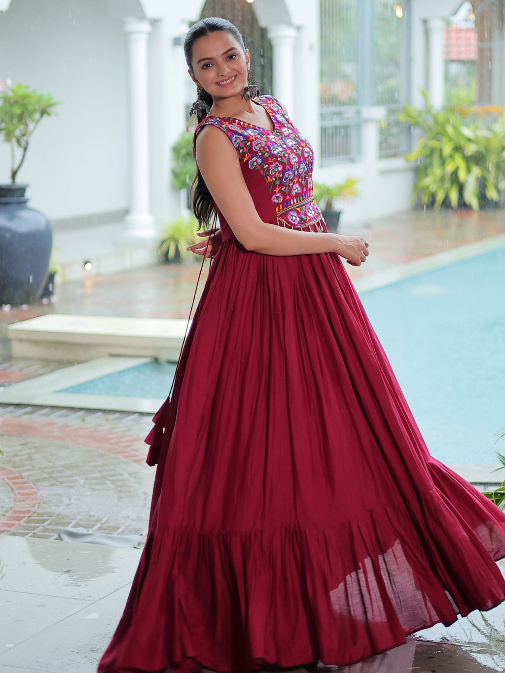 Maroon rayon sleeveless gown with kutchi gamthi embroidery and mirror work