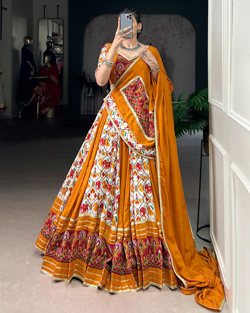 Mustard yellow rayon silk Patola print Gamthi work lehenga choli