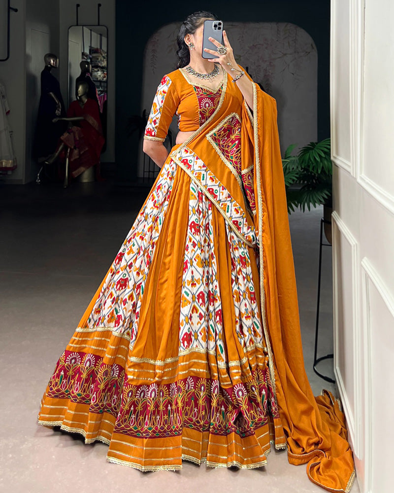 Mustard yellow rayon silk Patola print Gamthi work lehenga choli