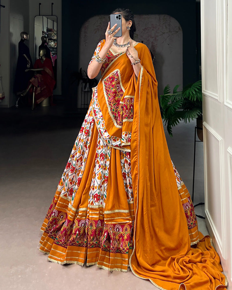 Mustard yellow rayon silk Patola print Gamthi work lehenga choli