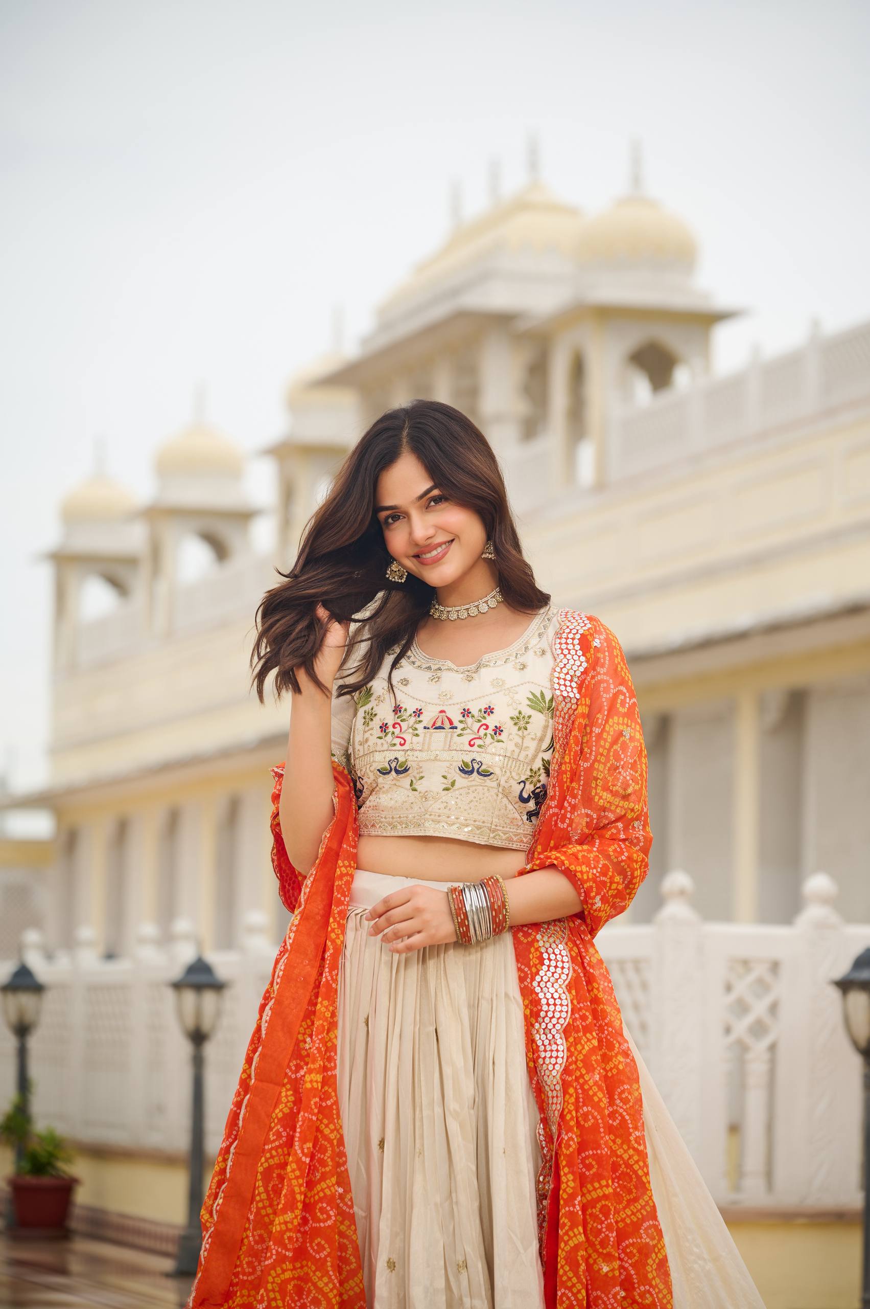 Off-white silk sequins thread embroidery lehenga choli with orange Bandhej dupatta