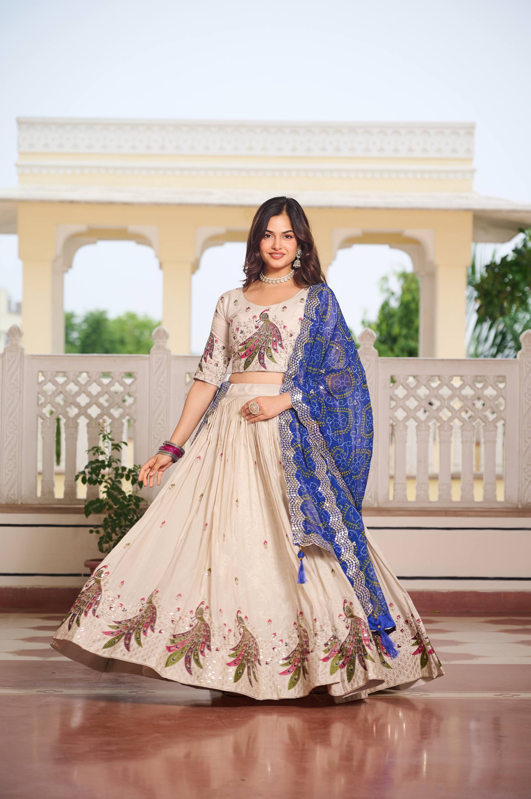 Amla off-white tissue silk lehenga choli with sequins thread work and blue Bandhej dupatta