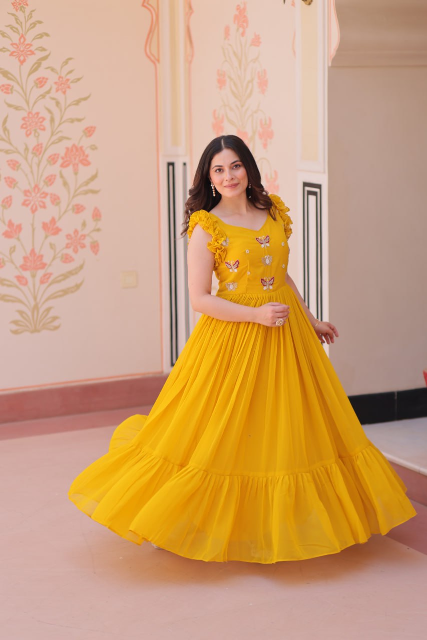 Lavi 7-meter flared designer gown in faux blooming fabric with sequin & bead embroidery, V-neck & frill shoulders – perfect for weddings & parties.