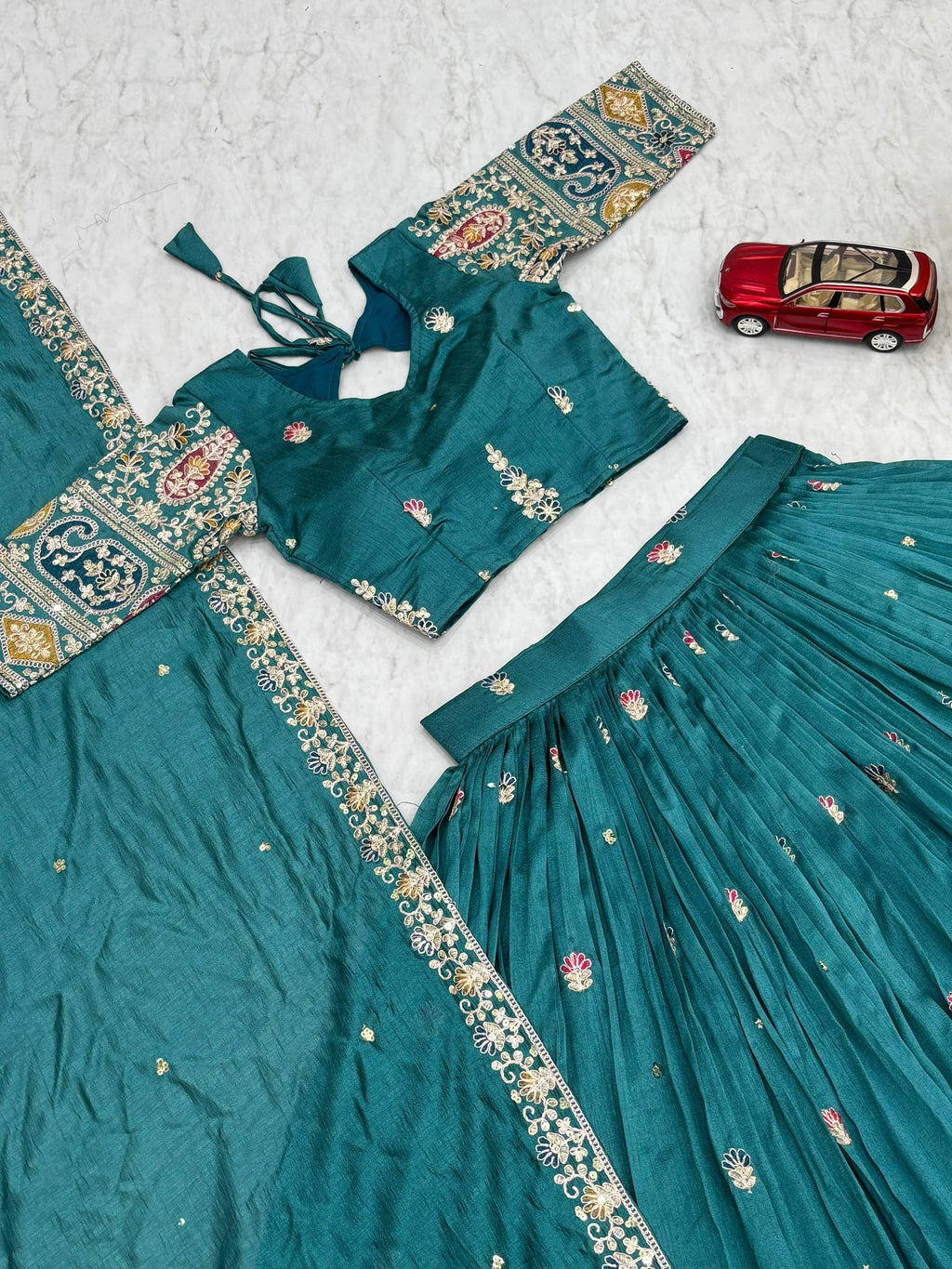 Raji teal green Vichitra silk lehenga choli with sequins thread embroidery and dupatta