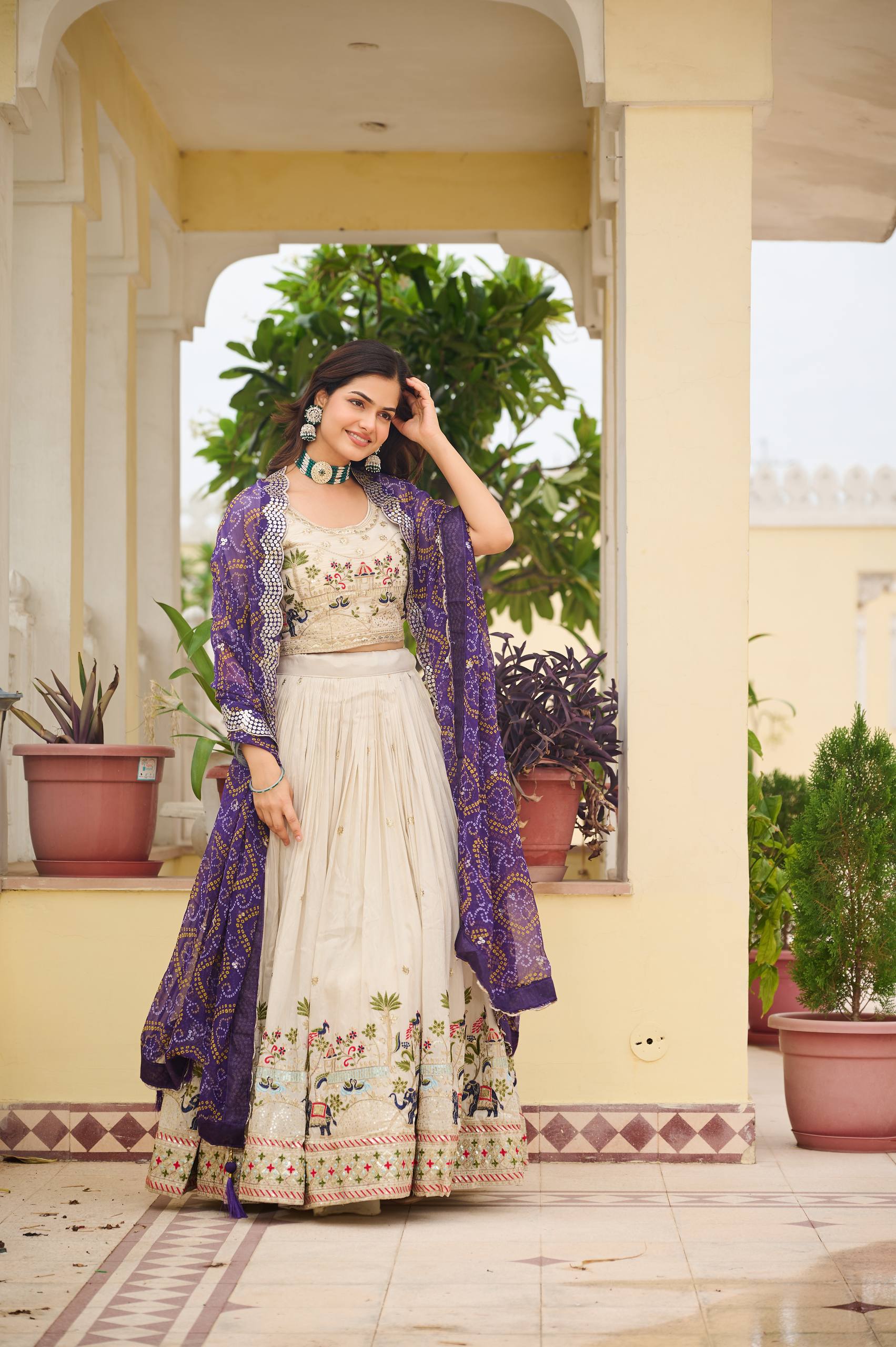 Off-white silk sequins thread embroidery lehenga choli with purple Bandhej dupatta