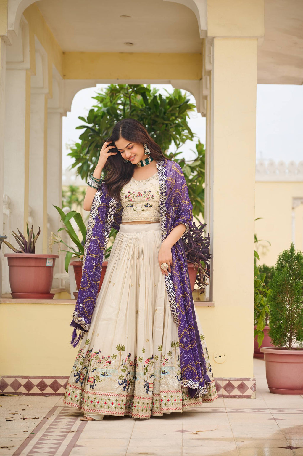 Off-white silk sequins thread embroidery lehenga choli with purple Bandhej dupatta