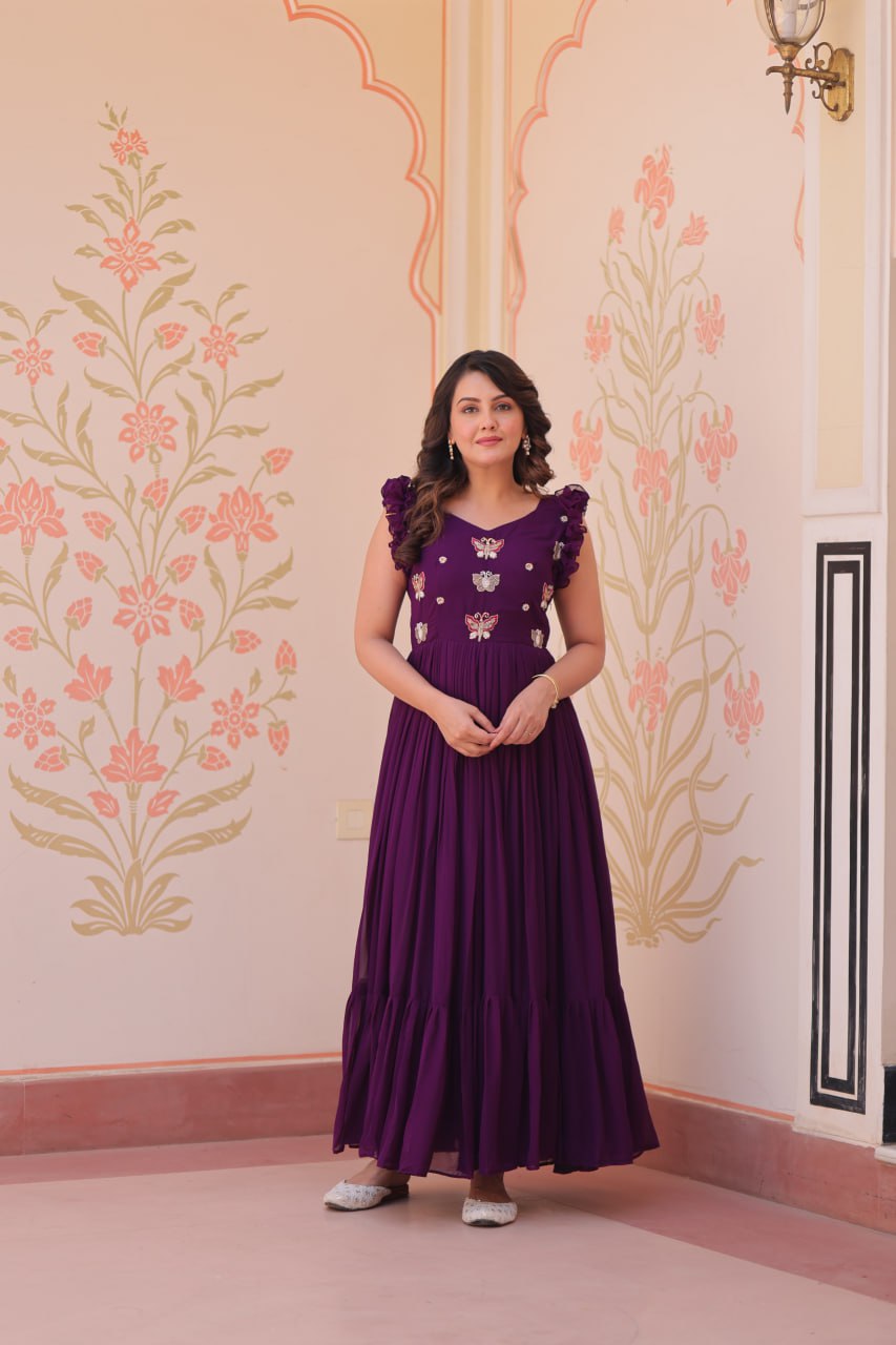 Lavi 7-meter flared designer gown in faux blooming fabric with sequin & bead embroidery, V-neck & frill shoulders – perfect for weddings & parties.
