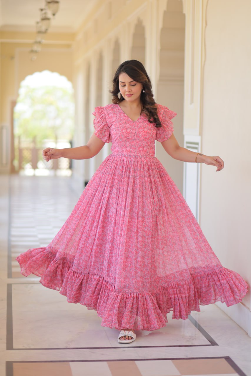 Printed pink georgette gown for women with 7-meter flair, bell sleeves & V-neck—lightweight ethnic dress for Haldi, Mehendi, Navratri & festive functions.