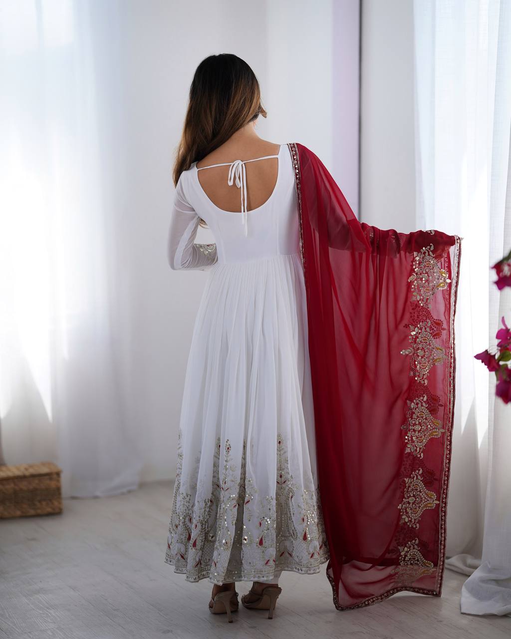 Tejvini White Embroidered Gown Set – heavy georgette gown with multi-thread 5mm sequin embroidery, full sleeves, soft cotton inner, paired with contrasting maroon embroidered dupatta and stitched bottom – ideal for weddings, receptions, and festive occasions.