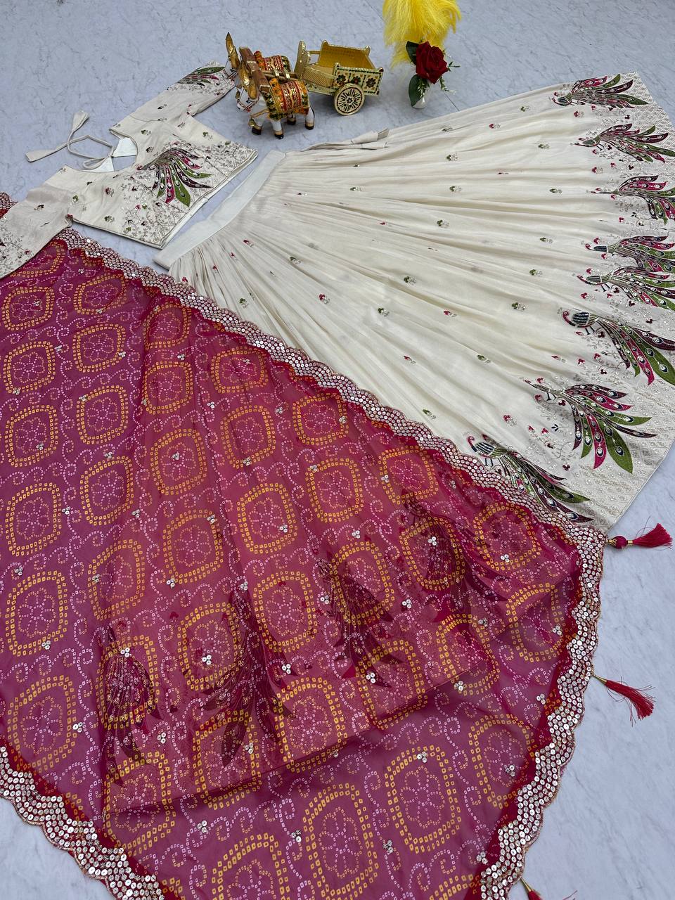 Amla off-white tissue silk lehenga choli with sequins thread work and pink Bandhej dupatta