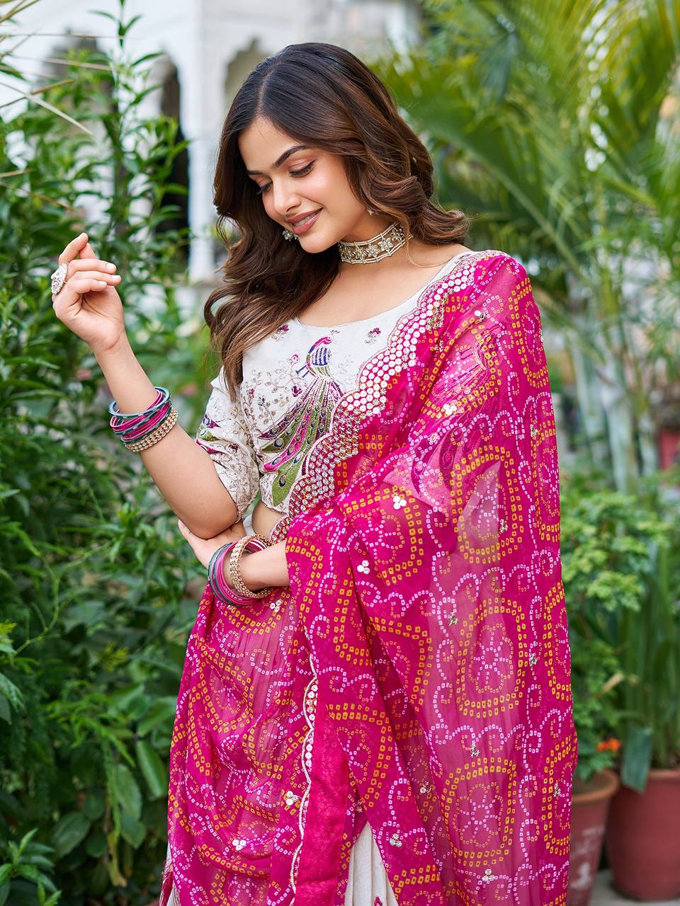 Amla off-white tissue silk lehenga choli with sequins thread work and pink Bandhej dupatta