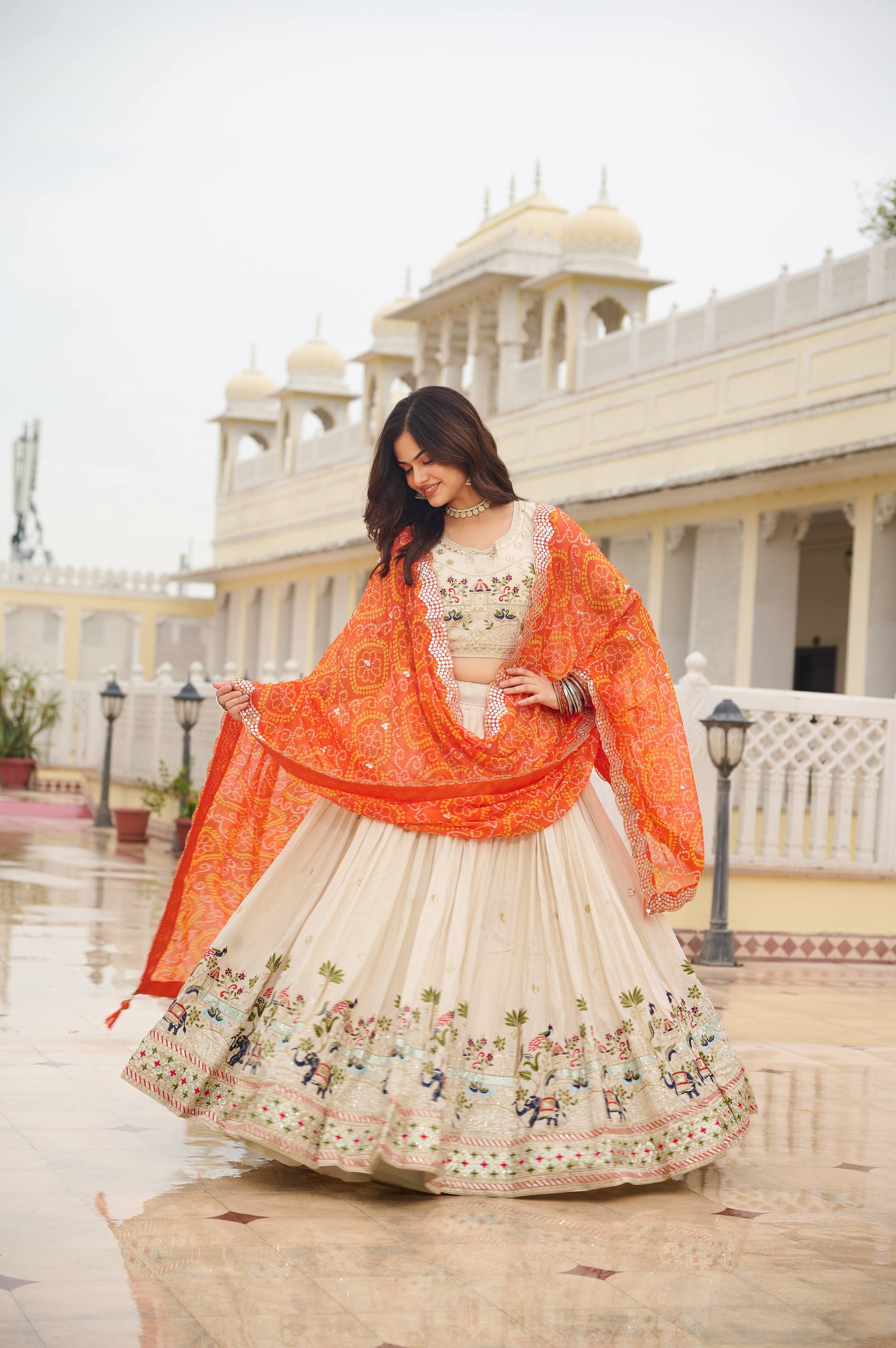Off-white silk sequins thread embroidery lehenga choli with orange Bandhej dupatta