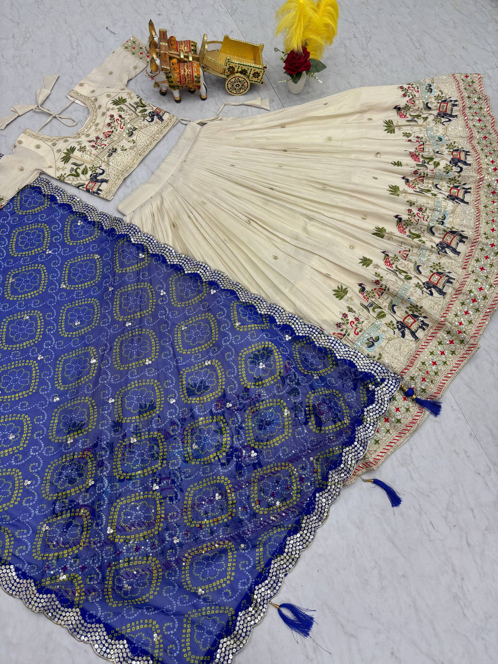Off-white silk sequins thread embroidery lehenga choli with blue Bandhej dupatta