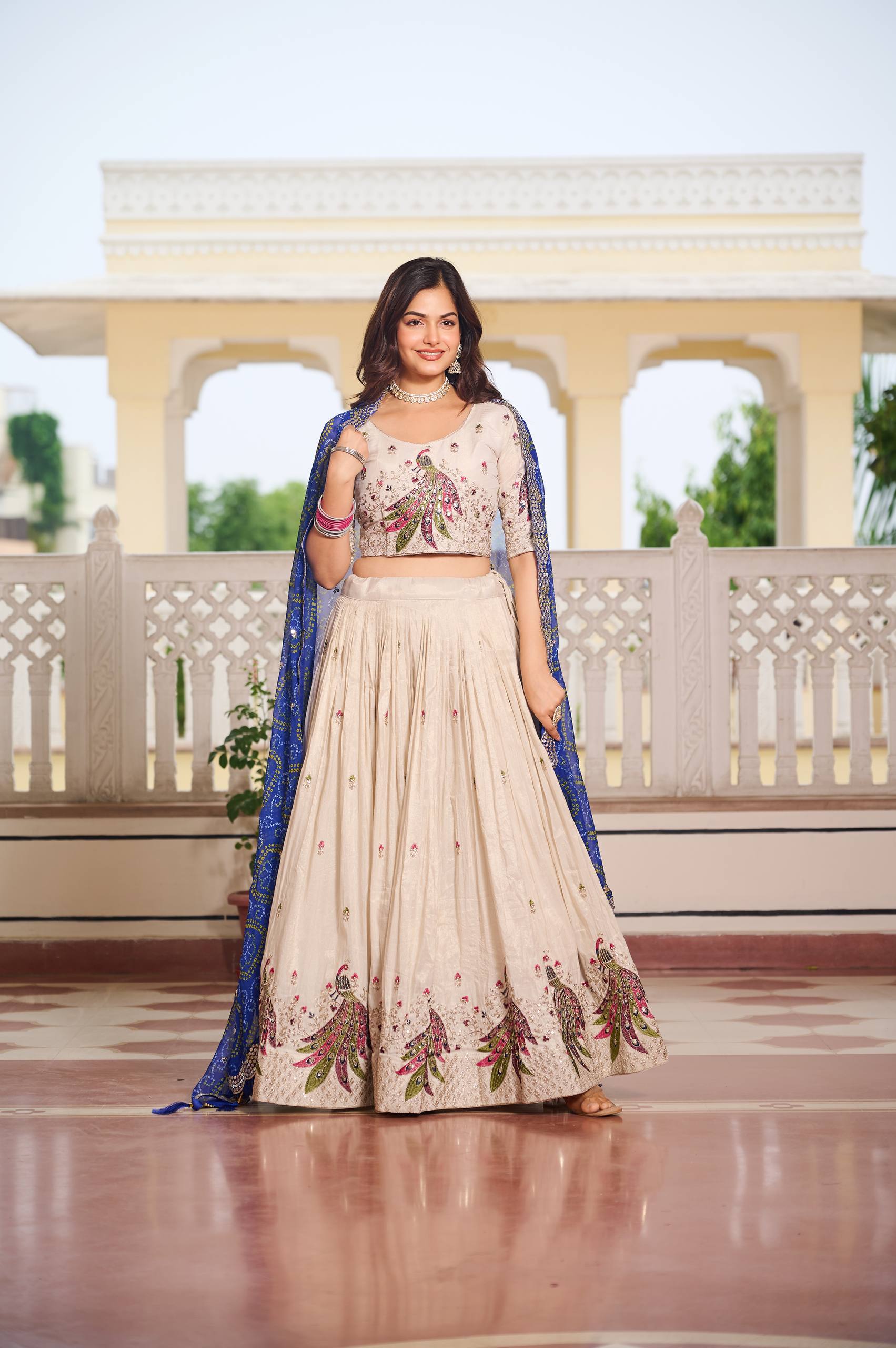 Amla off-white tissue silk lehenga choli with sequins thread work and blue Bandhej dupatta