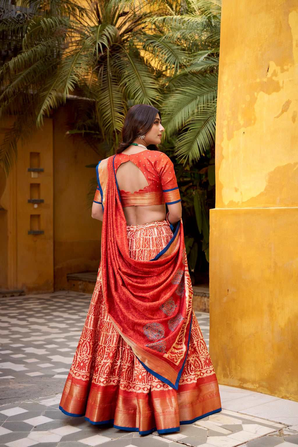Girija rust orange Dola silk batik print lehenga choli with zari weaving work
