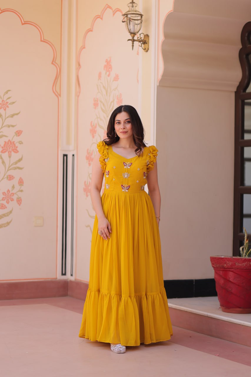 Lavi 7-meter flared designer gown in faux blooming fabric with sequin & bead embroidery, V-neck & frill shoulders – perfect for weddings & parties.