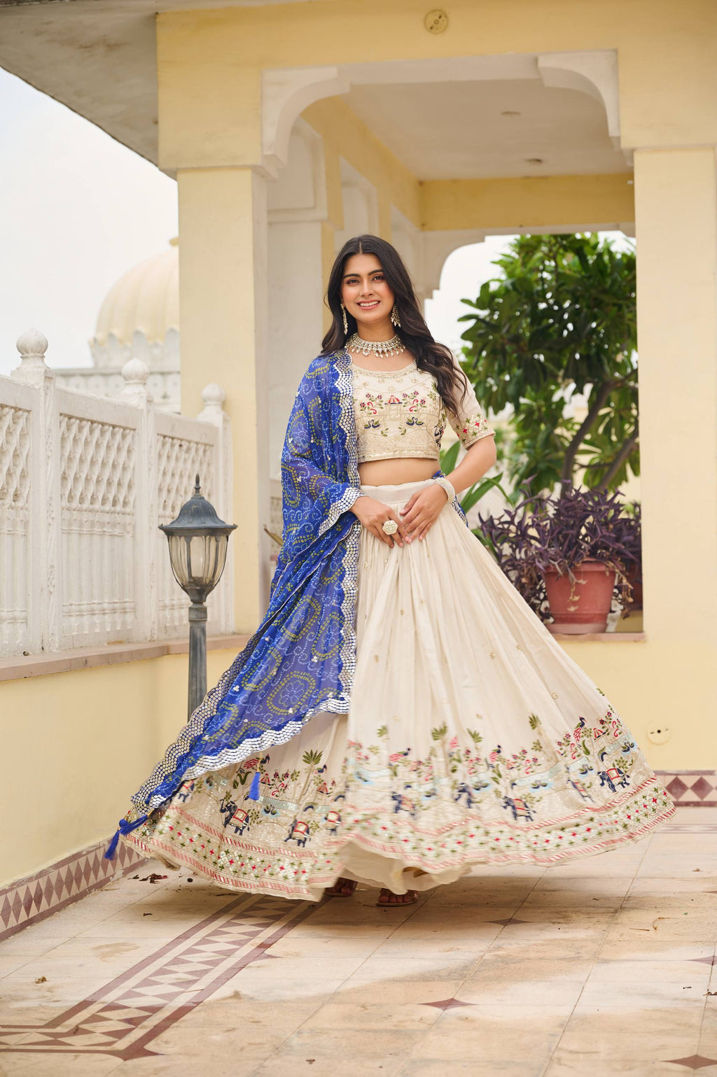 Off-white silk sequins thread embroidery lehenga choli with blue Bandhej dupatta