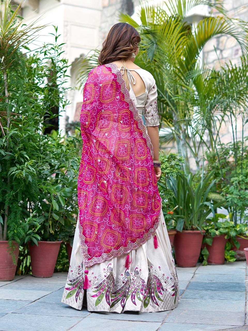 Amla off-white tissue silk lehenga choli with sequins thread work and pink Bandhej dupatta