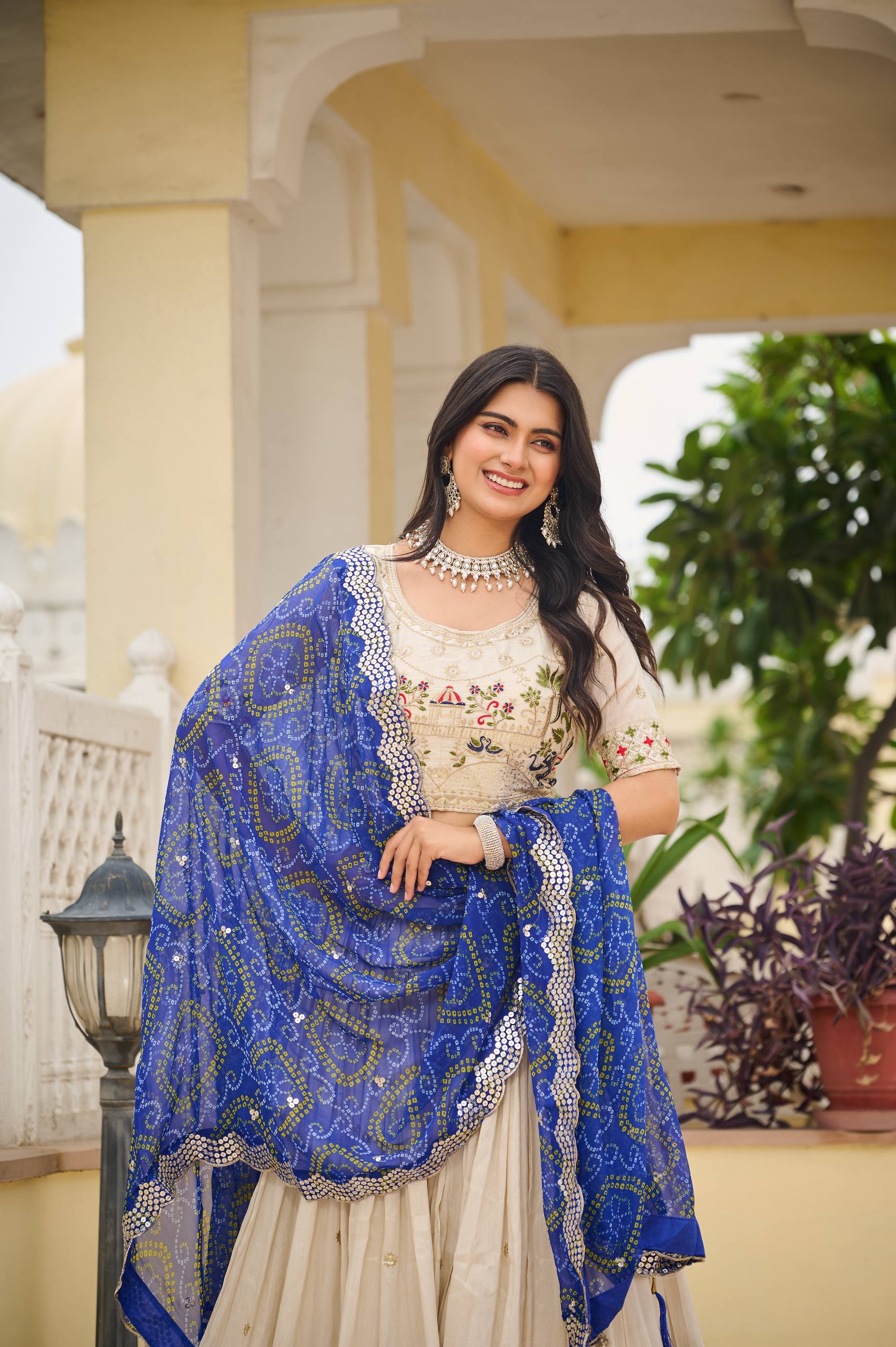Off-white silk sequins thread embroidery lehenga choli with blue Bandhej dupatta