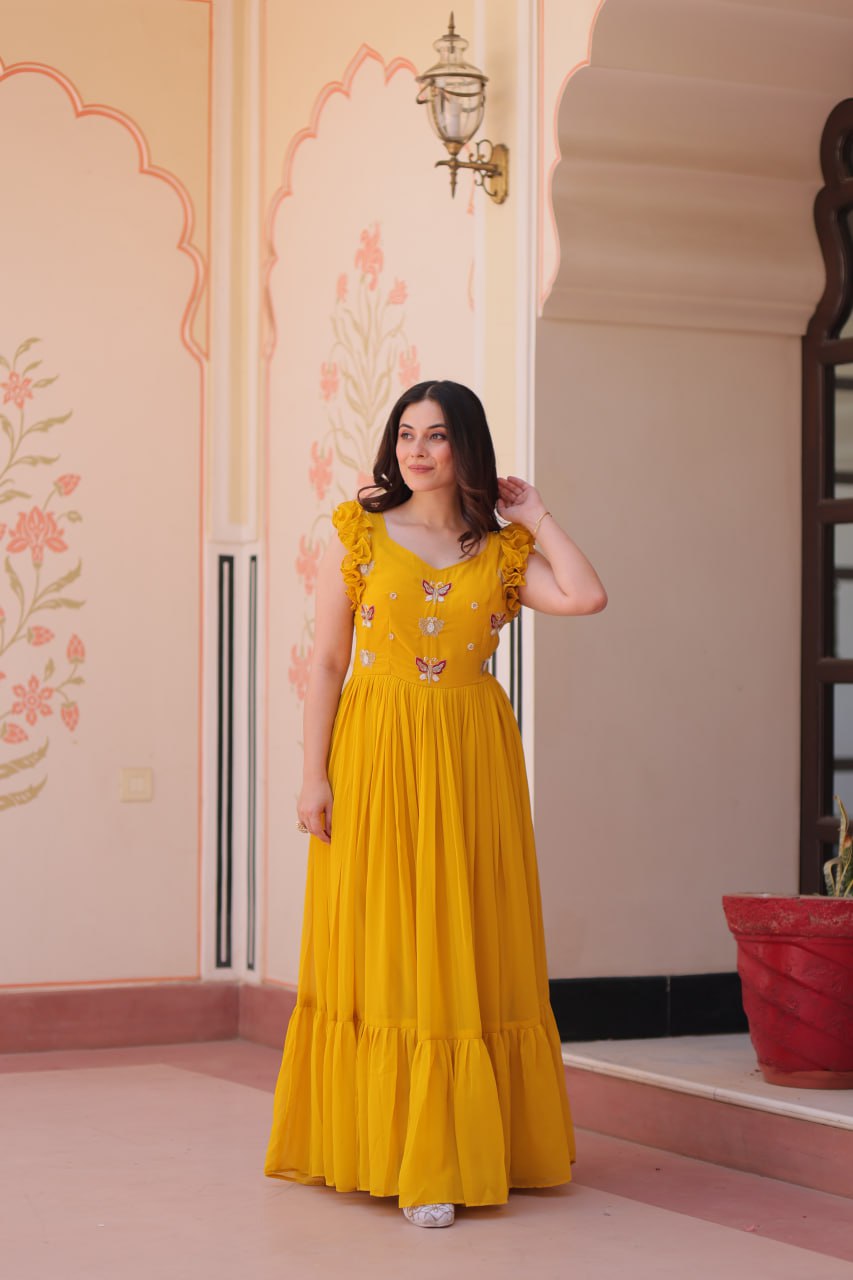 Lavi 7-meter flared designer gown in faux blooming fabric with sequin & bead embroidery, V-neck & frill shoulders – perfect for weddings & parties.