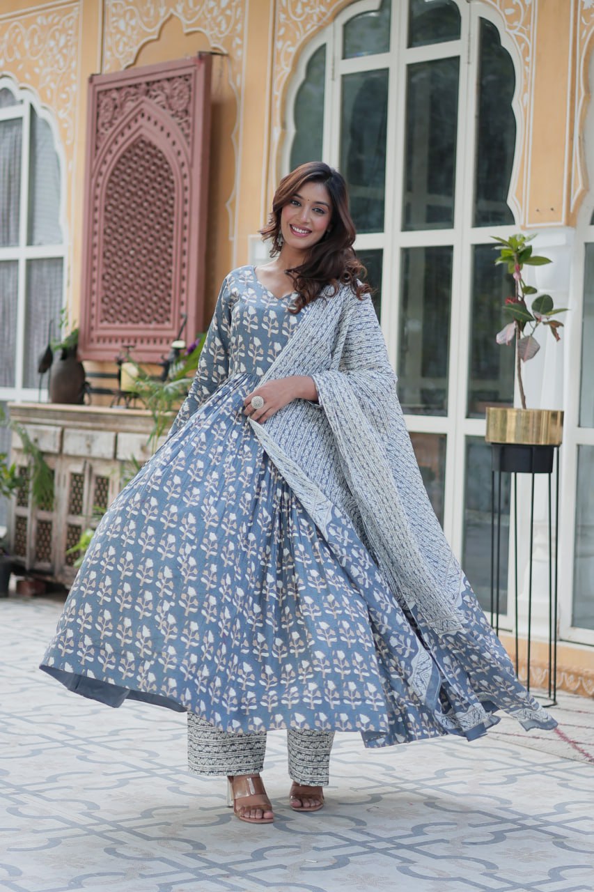 The Ridhvini Orange Cotton Anarkali Set is a stylish and comfortable ethnic wear choice for women, crafted from premium pure cotton. This readymade Anarkali suit set features a long Anarkali kurti with a fancy V-neck and full sleeves, paired with breathable cotton straight pants and a matching cotton dupatta. Ideal for daily wear, office wear, and festive occasions, this lightweight Anarkali cotton kurta set is designed for effortless elegance. Whether you're looking for a casual cotton suit, summer ethnic 