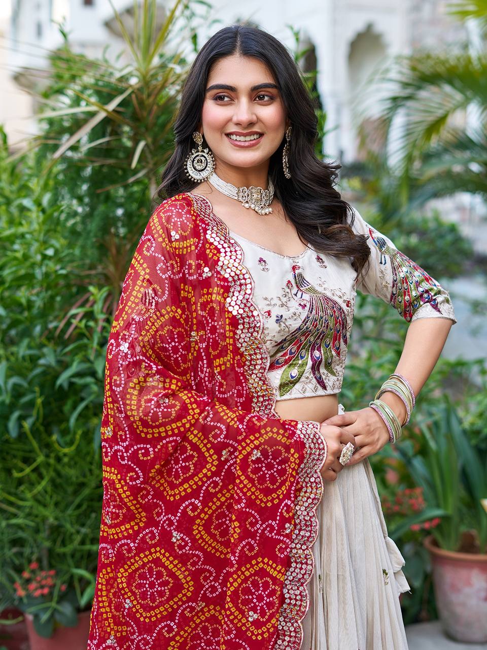 Amla off-white tissue silk lehenga choli with sequins thread work and red Bandhej dupatta