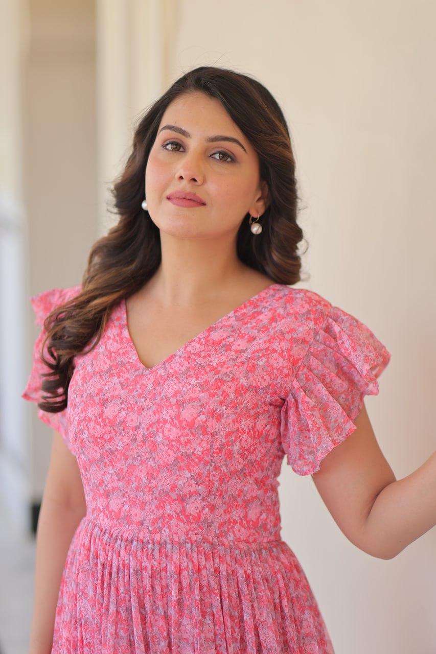 Printed pink georgette gown for women with 7-meter flair, bell sleeves & V-neck—lightweight ethnic dress for Haldi, Mehendi, Navratri & festive functions.