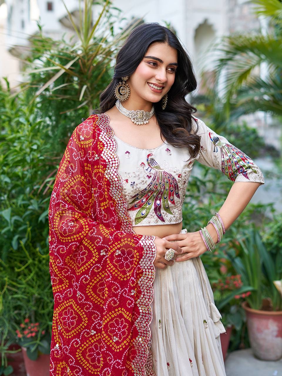 Amla off-white tissue silk lehenga choli with sequins thread work and red Bandhej dupatta