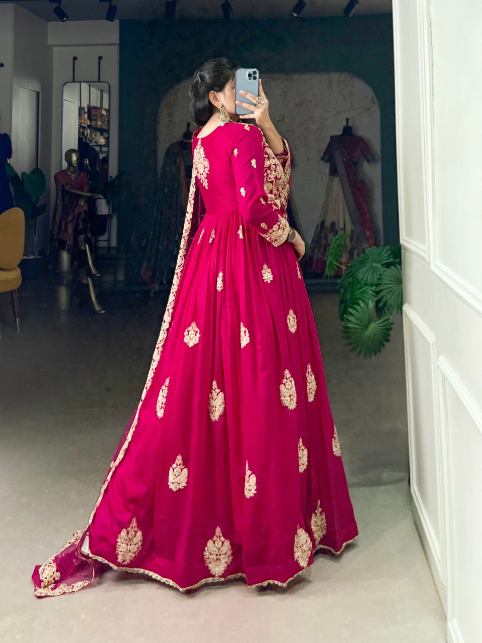 Anwitha Pink Embroidered Silk Anarkali Gown Set, crafted from luxurious Vichitra Silk with intricate sequins and thread embroidery accented by delicate lace details. This fully stitched Anarkali gown features a 3-meter flair and a soft cotton lining for comfort. Paired with a graceful net dupatta adorned with sequins embroidery and a lace border, this elegant ensemble is perfect for weddings, festive occasions, and grand celebrations