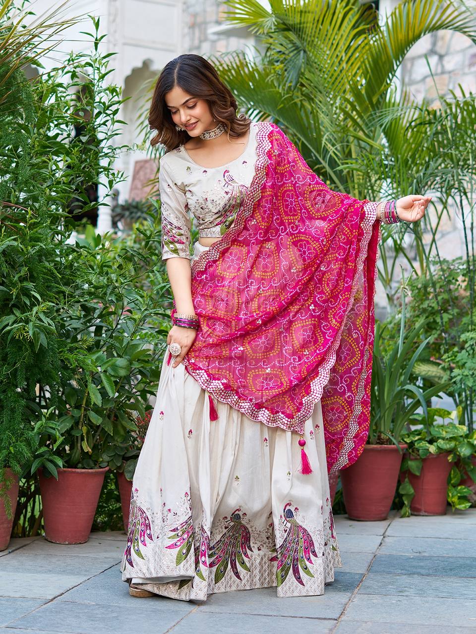 Amla off-white tissue silk lehenga choli with sequins thread work and pink Bandhej dupatta