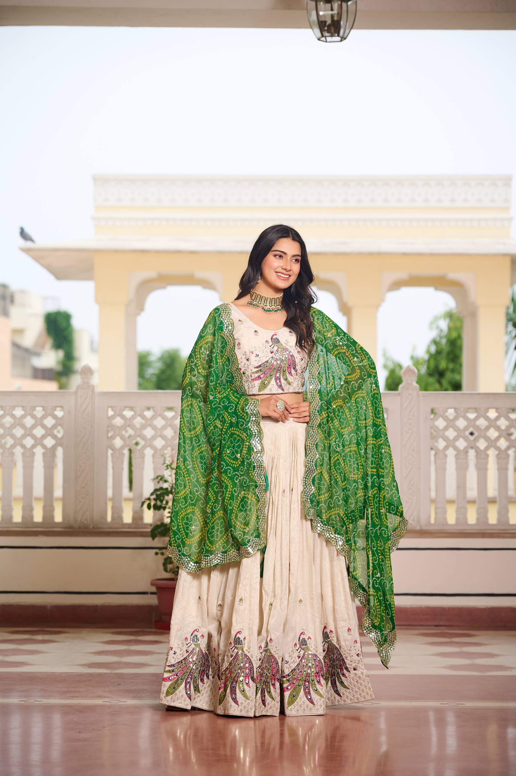 Amla off-white tissue silk lehenga choli with sequins thread work and green Bandhej dupatta