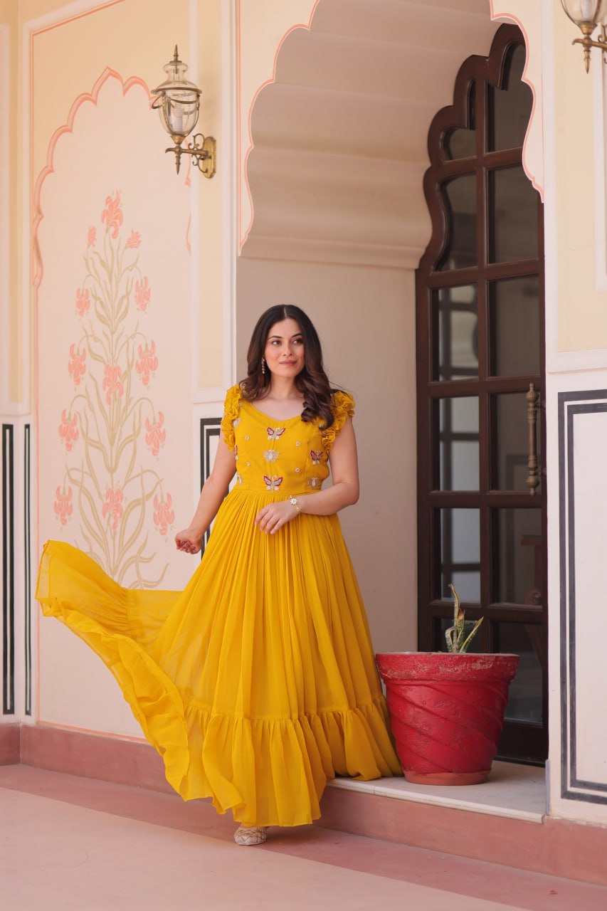 Lavi 7-meter flared designer gown in faux blooming fabric with sequin & bead embroidery, V-neck & frill shoulders – perfect for weddings & parties.