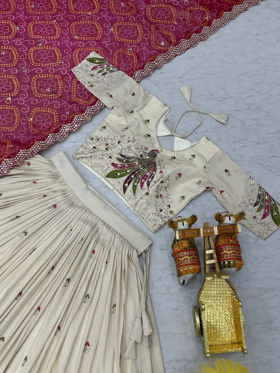 Amla off-white tissue silk lehenga choli with sequins thread work and pink Bandhej dupatta