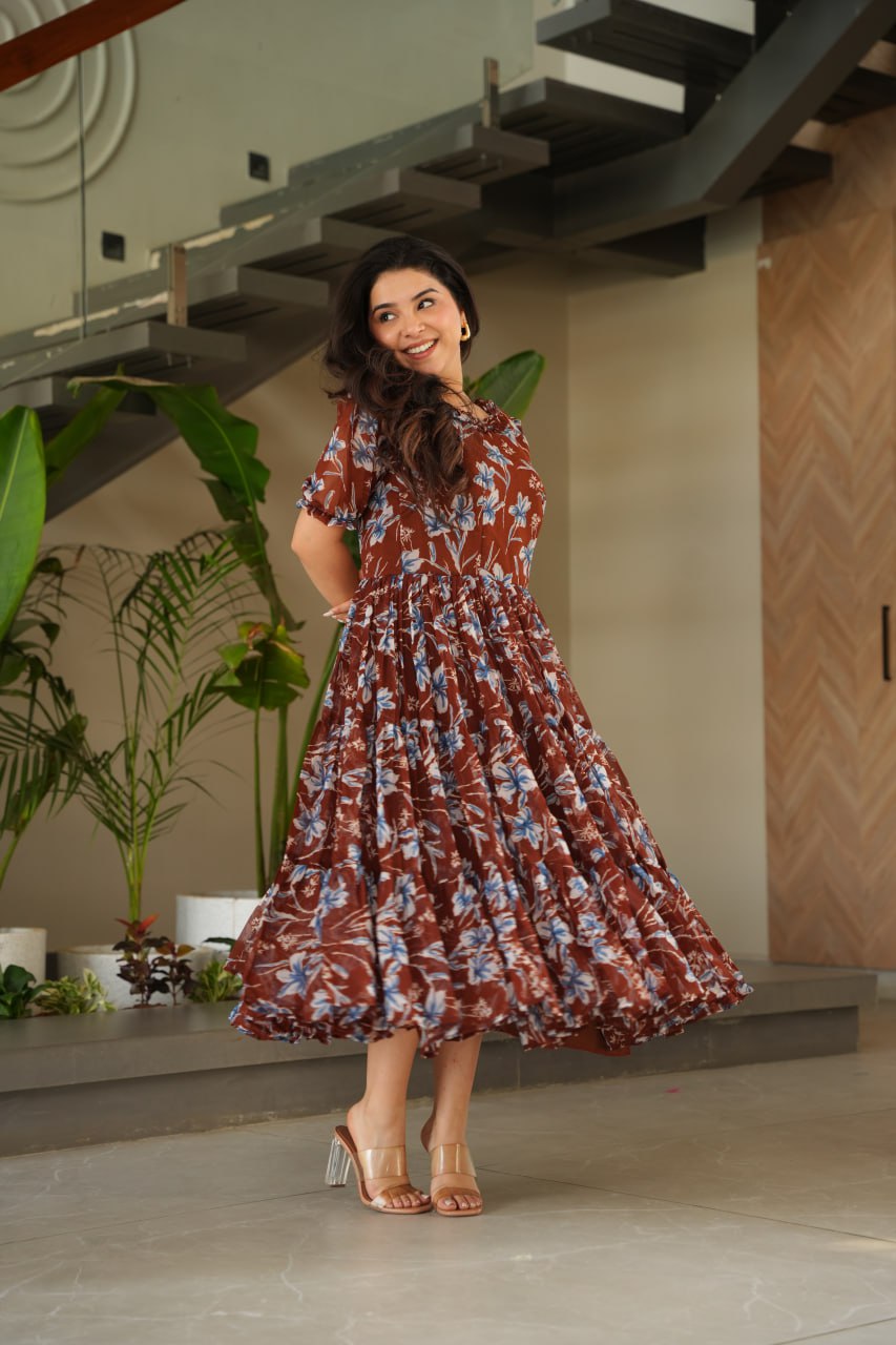 Vikarni Brown Printed Anarkali Gown in faux georgette with 12-meter flair & cotton lining – perfect for haldi, mehndi, festive & Indo-western occasions.