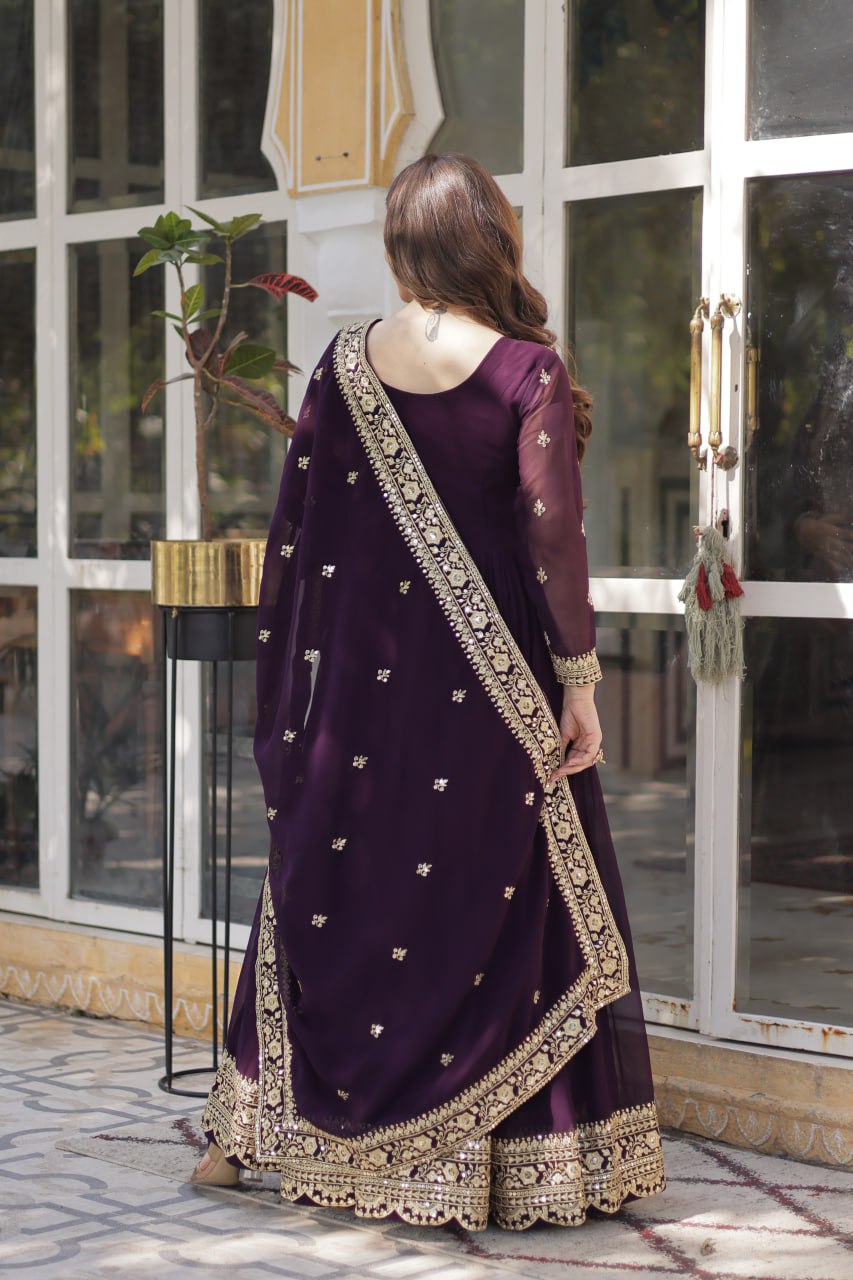 Suvarnita wine embroidered ethnic gown set with zari and sequin work, featuring full sleeves, round neck, flared 56-inch faux blooming gown and matching dupatta – ideal Indian party wear gown for weddings and festive occasions.