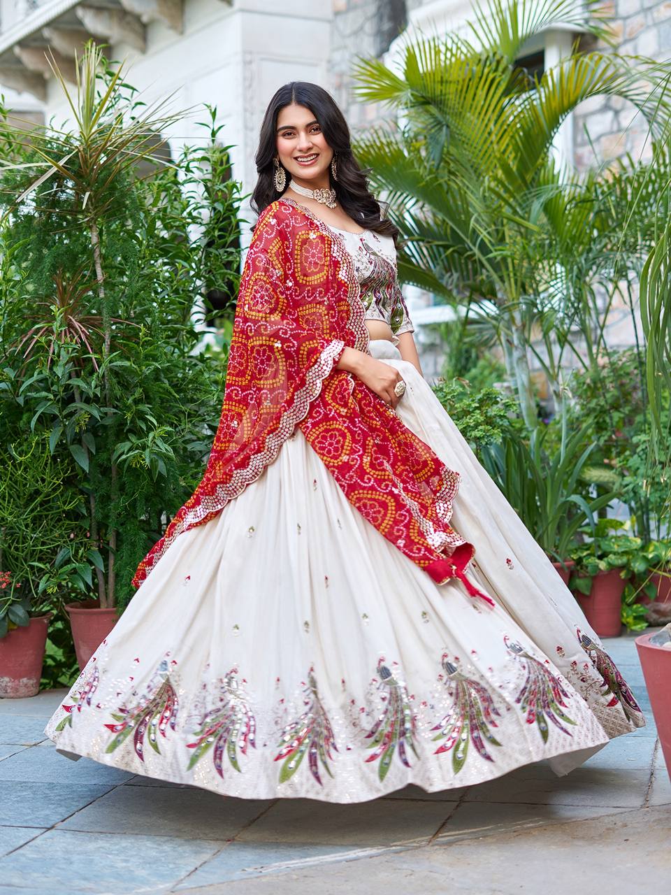 Amla off-white tissue silk lehenga choli with sequins thread work and red Bandhej dupatta