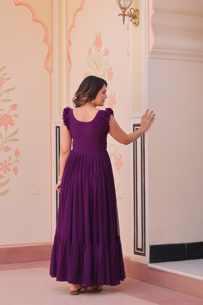 Lavi 7-meter flared designer gown in faux blooming fabric with sequin & bead embroidery, V-neck & frill shoulders – perfect for weddings & parties.