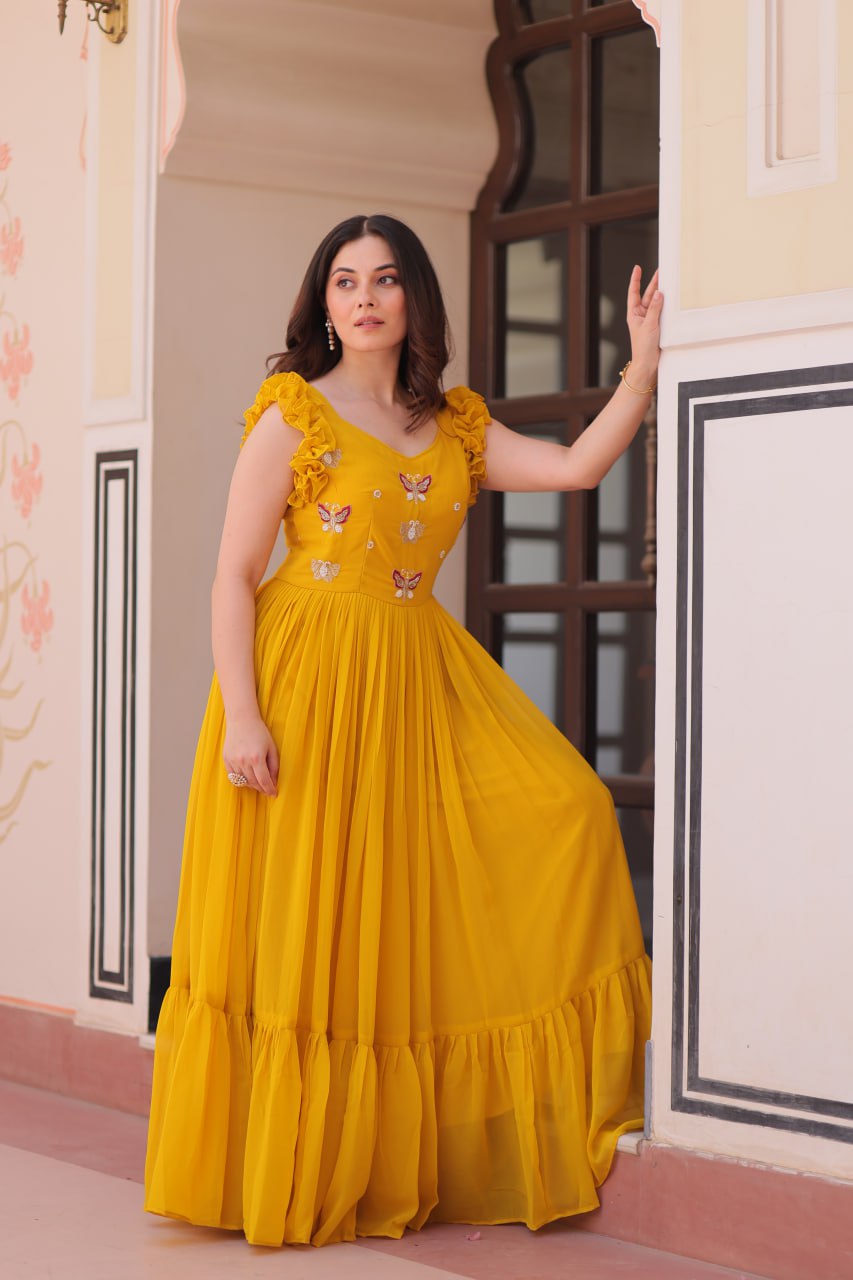 Lavi 7-meter flared designer gown in faux blooming fabric with sequin & bead embroidery, V-neck & frill shoulders – perfect for weddings & parties.