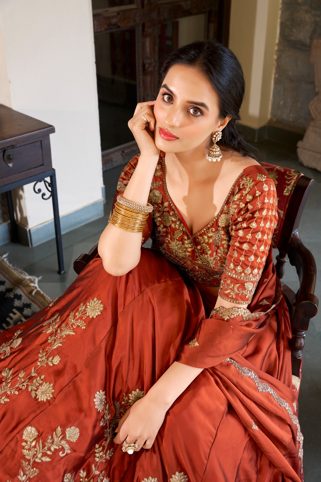 Rust orange rangoli silk lehenga choli with embroidered sequins work
