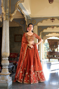 Rust orange rangoli silk lehenga choli with embroidered sequins work