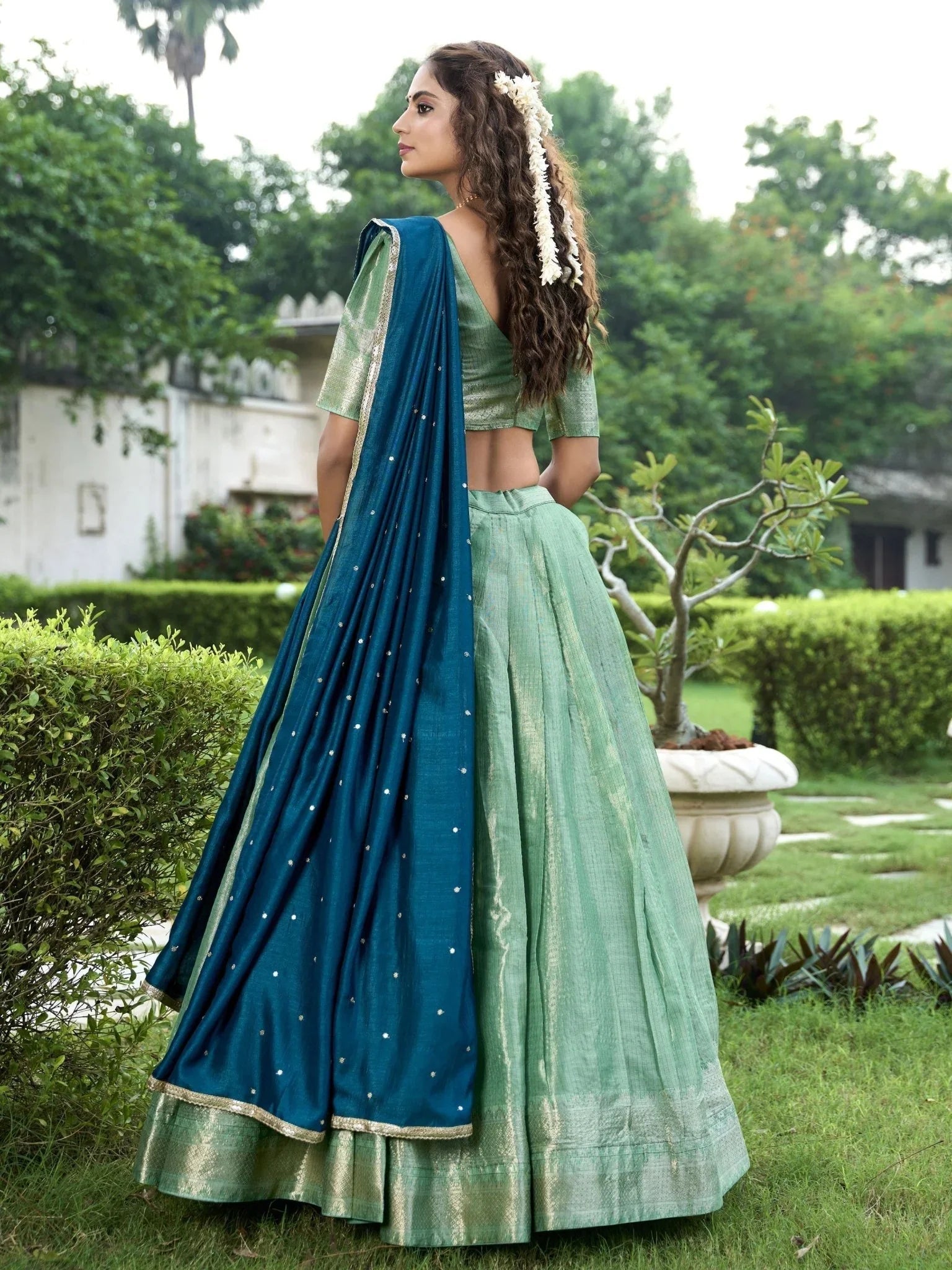 Sea green kanchipuram silk lehenga choli with zari weaving and sequins embroidery