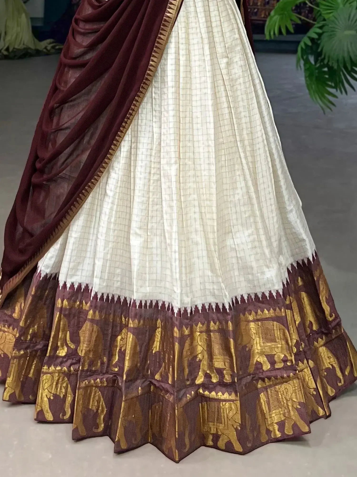 White traditional half-saree lehenga with chex pattern and zari work