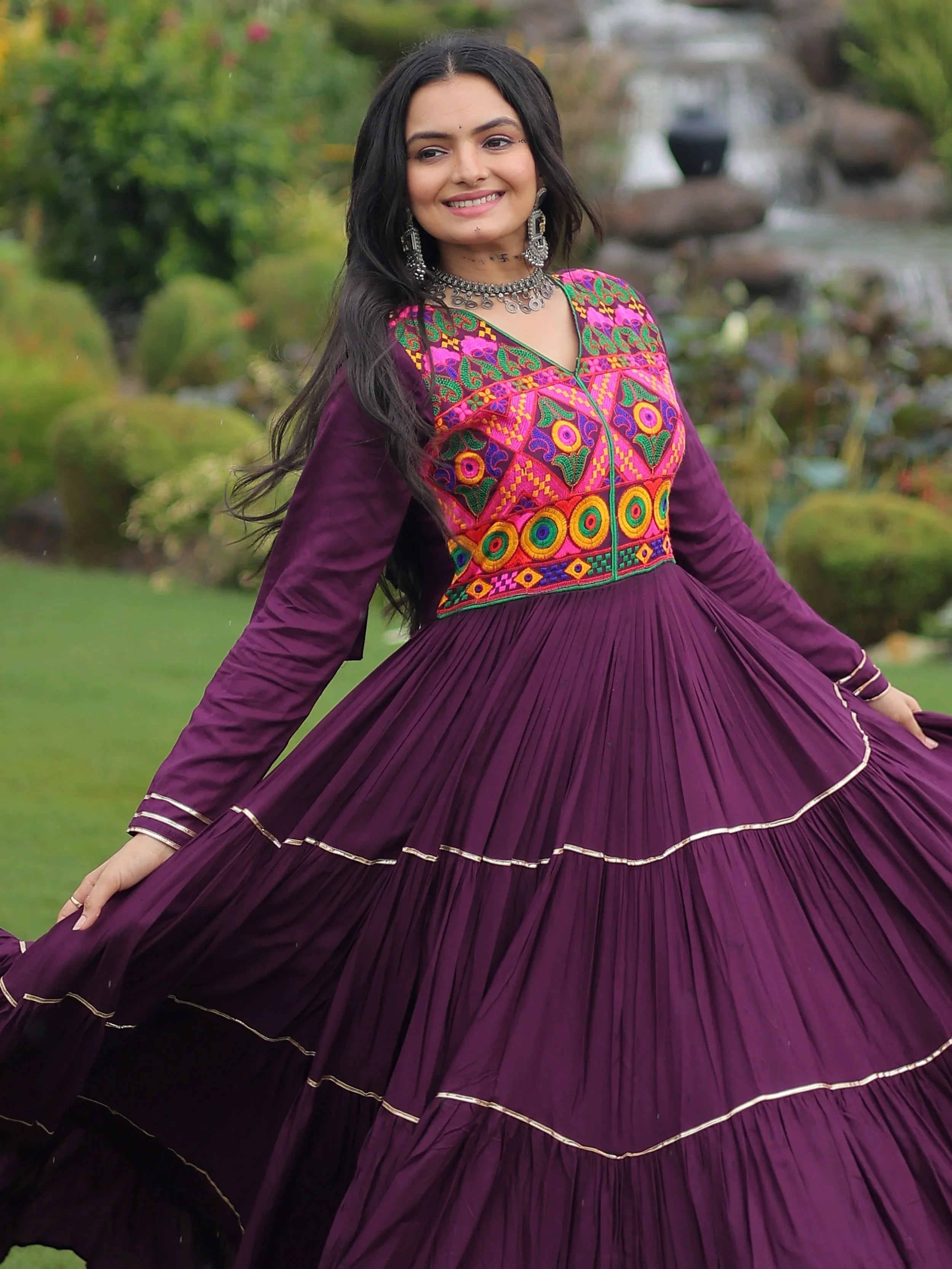 Wine coloured rayon flair gown with kutchi gamthi embroidery and mirror work