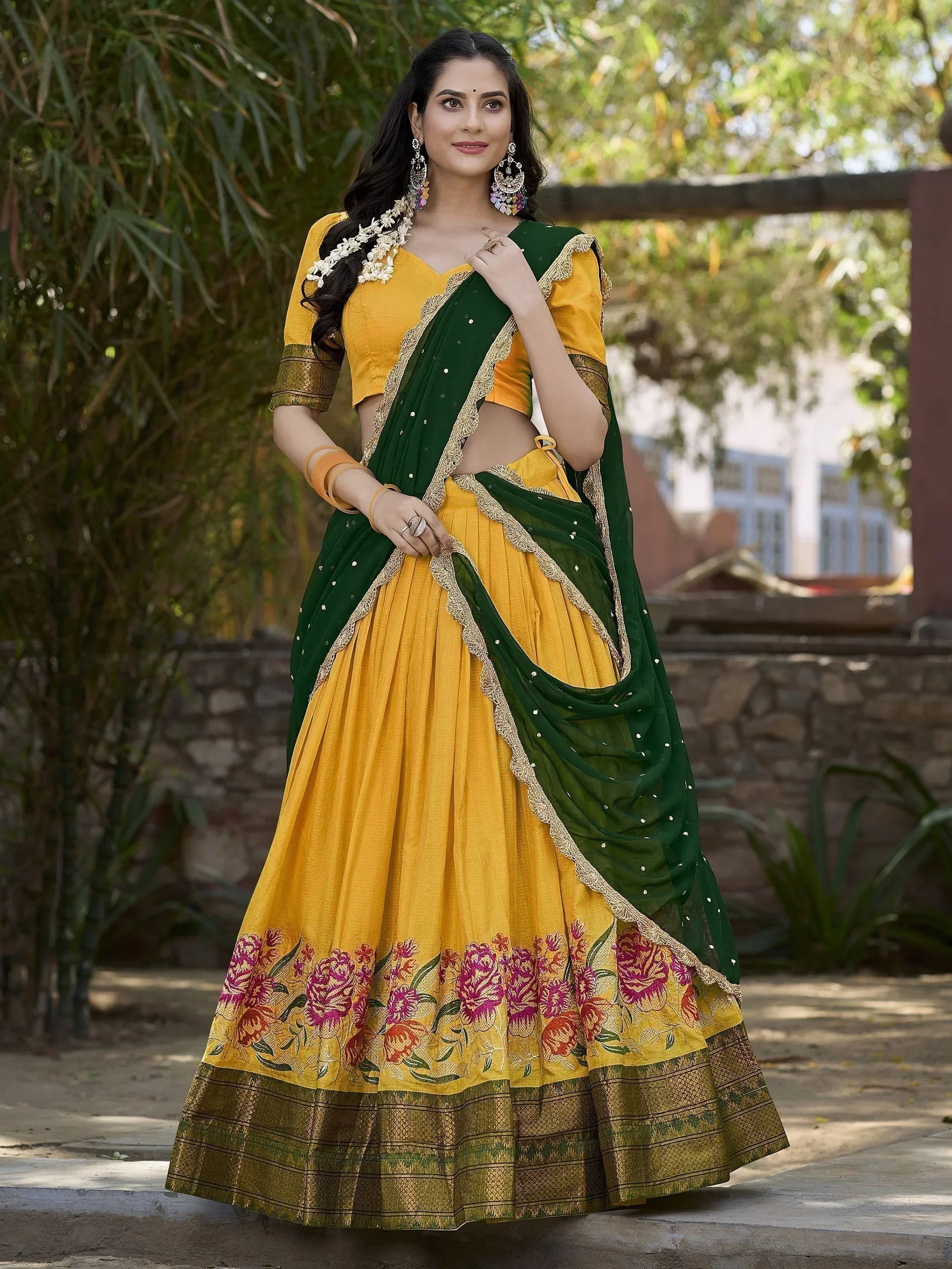 Elegant yellow cotton silk lehenga choli set with intricate embroidery and dupatta