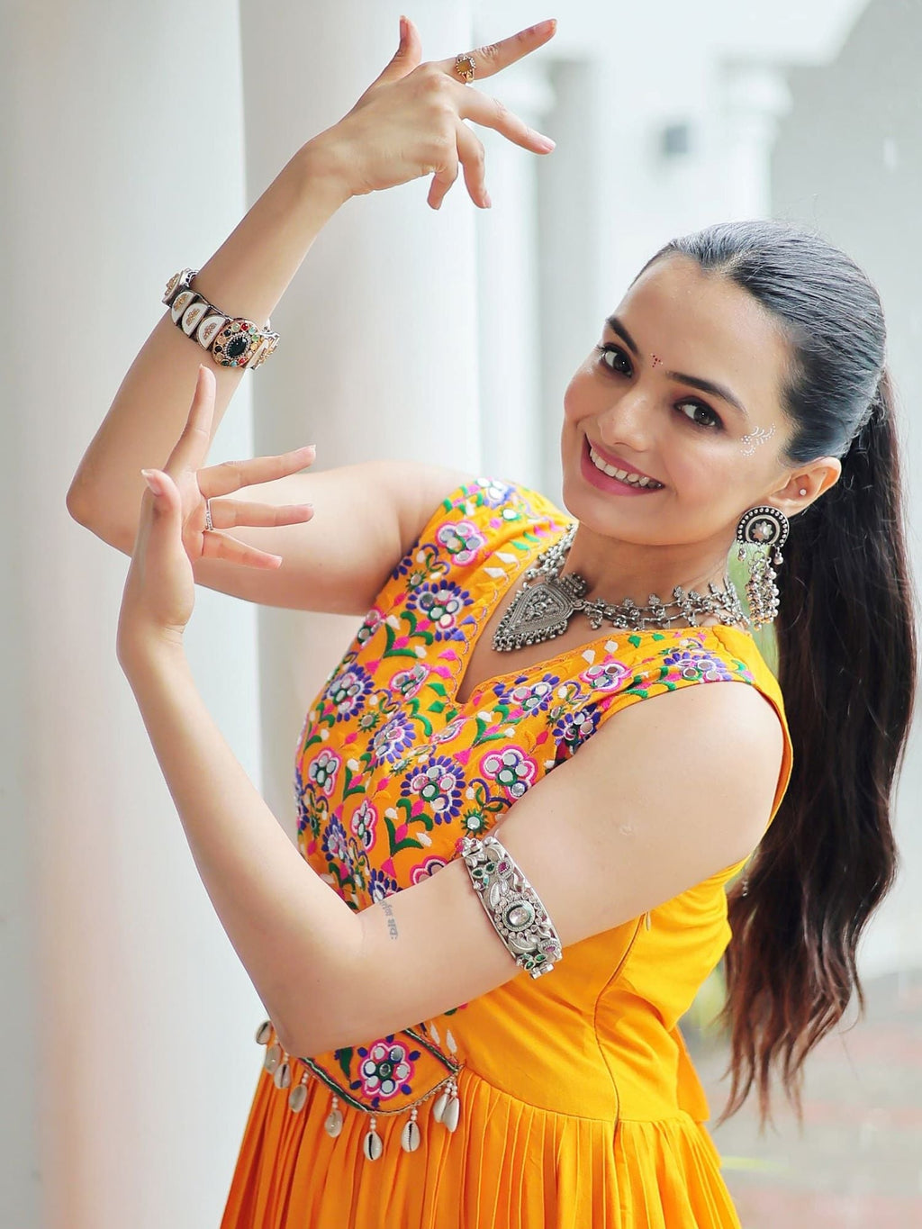Yellow rayon sleeveless gown with kutchi gamthi embroidery and mirror work